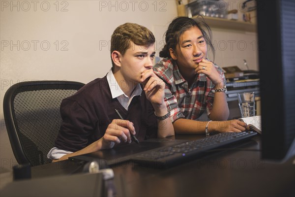 Teenage boys using computer
