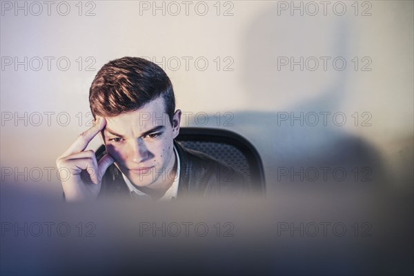 Caucasian teenage boy using computer