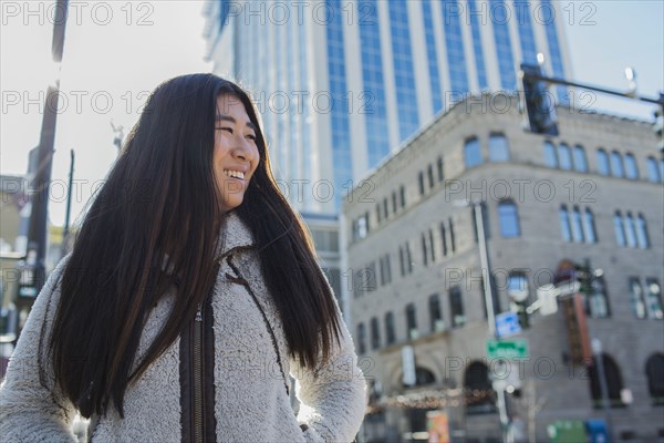 Chinese teenage girl smiling outdoors