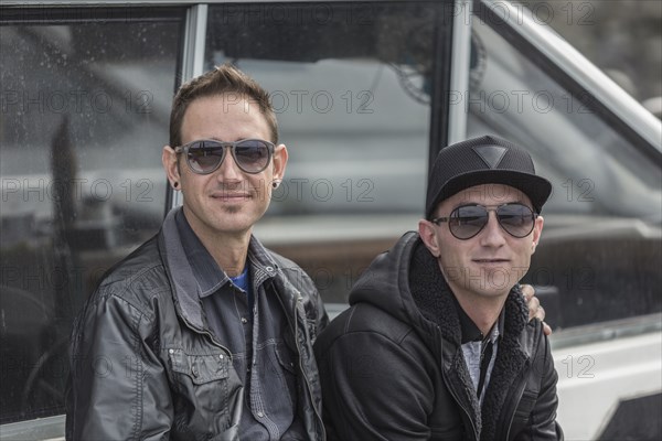 Caucasian men sitting near boat