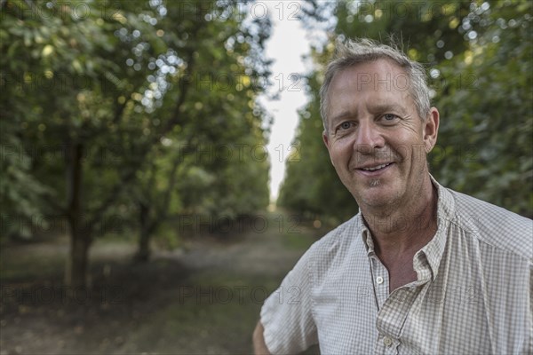 Portrait of smiling Caucasian man in orchard