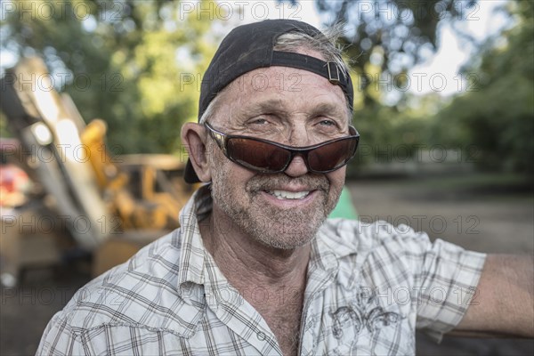 Portrait of Caucasian man wearing sunglasses and baseball cap