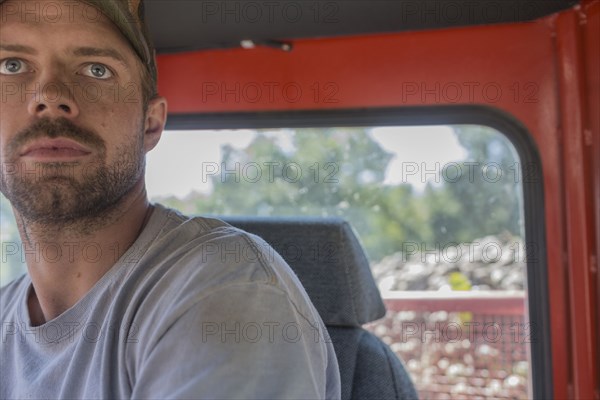 Portrait of serious Caucasian man in tractor