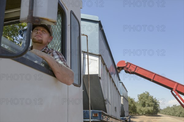 Caucasian man watching harvester