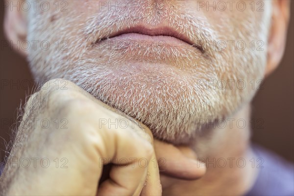 Close up of Caucasian man with hand on chin