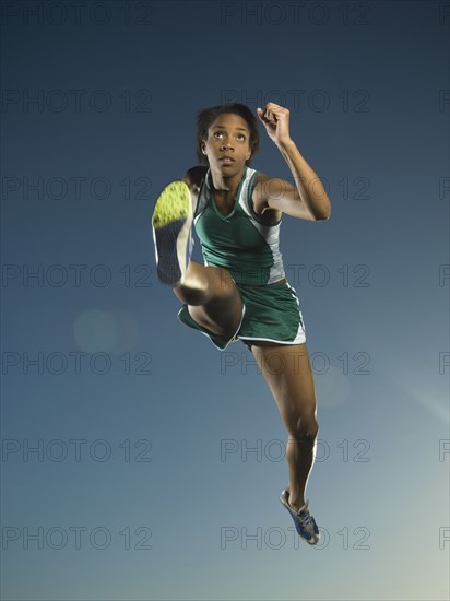 African American female athlete jumping