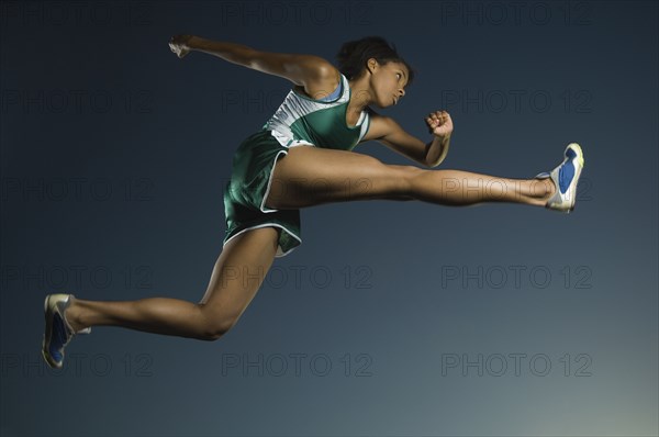 African American female athlete jumping