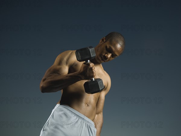 African American man lifting weights