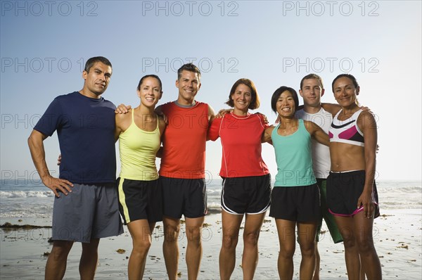 Multi-ethnic runners at beach