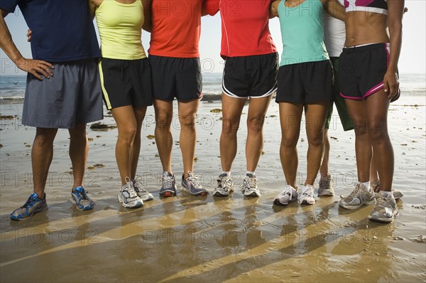 Multi-ethnic runners at beach