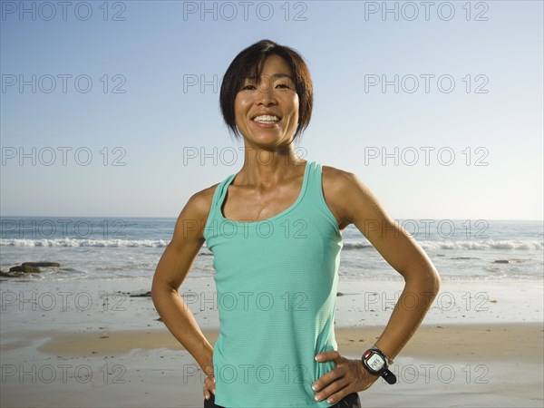 Asian woman with hands on hips