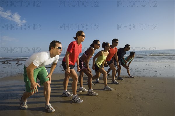 Multi-ethnic runners racing at beach