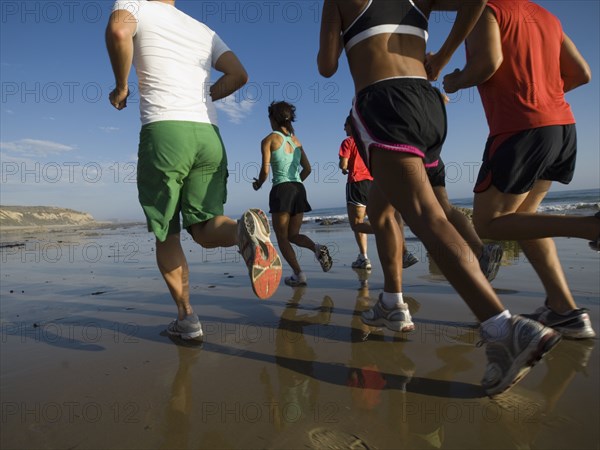 Multi-ethnic runners racing at beach