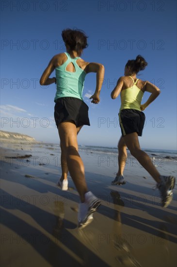 Multi-ethnic female runners racing at beach