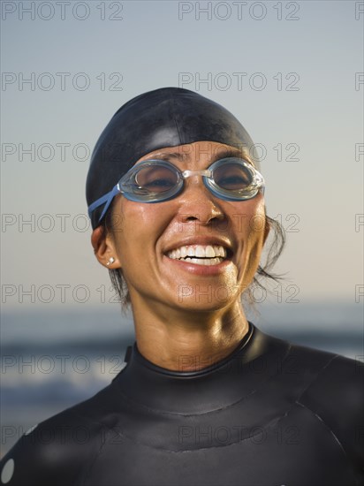 Asian woman wearing wetsuit and goggles