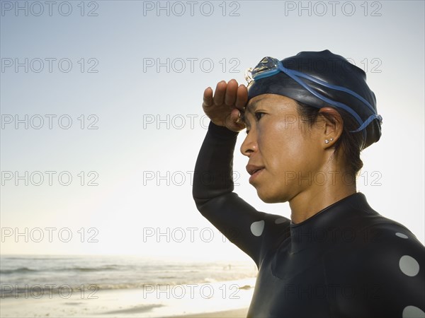 Asian woman wearing wetsuit and goggles