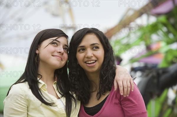 Multi-ethnic teenaged girls hugging