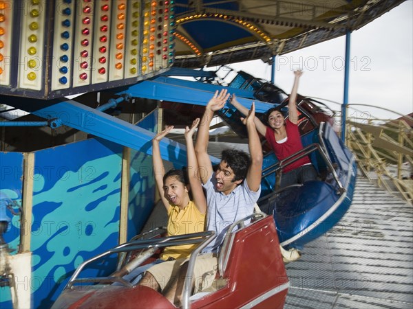 Multi-ethnic teenaged friends on carnival ride