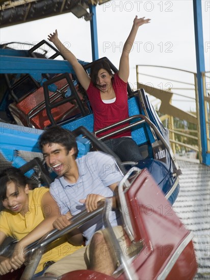 Multi-ethnic teenaged friends on carnival ride