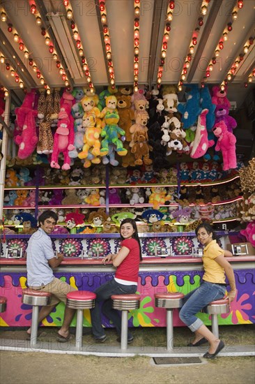 Multi-ethnic teenaged friends at carnival booth