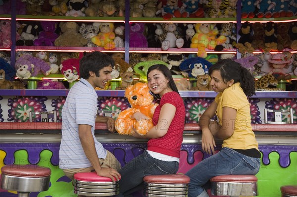 Multi-ethnic teenaged friends at carnival booth