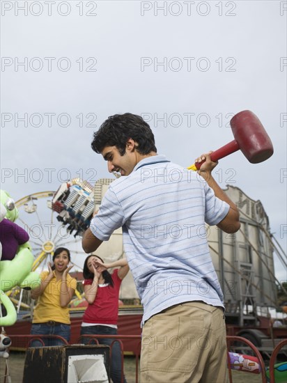 Mixed Race teenaged boy playing carnival game