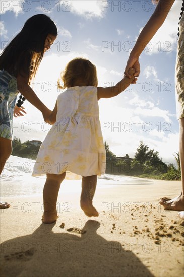 Pacific Islander toddler walking on beach