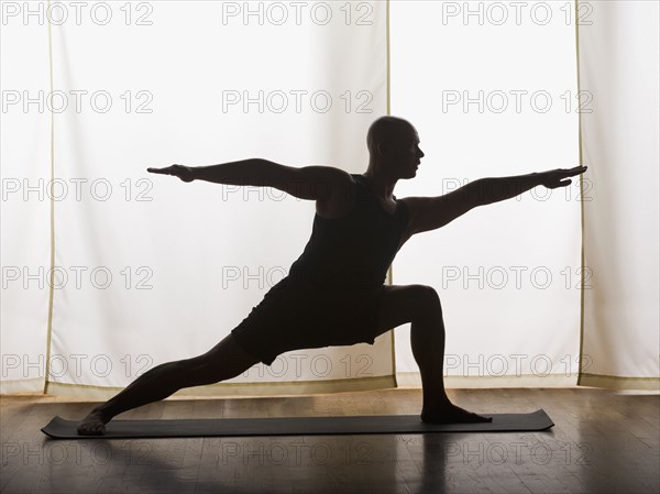 Hispanic man practicing yoga