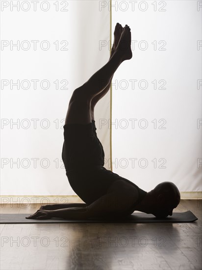 Hispanic man practicing yoga