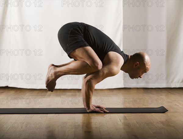 Hispanic man practicing yoga