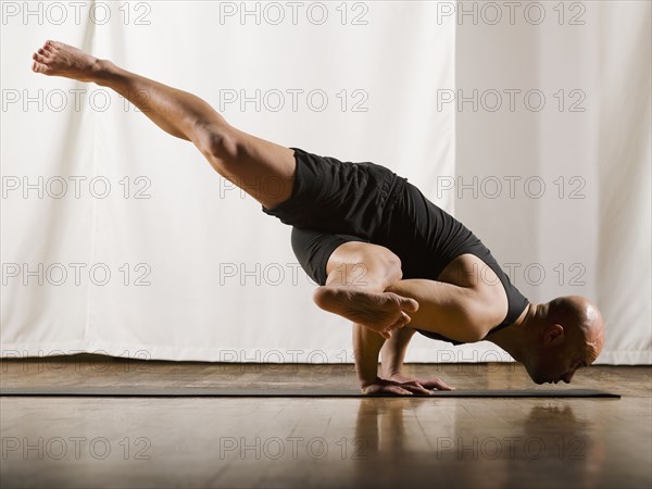 Hispanic man practicing yoga