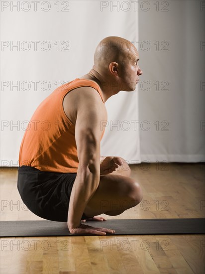 Hispanic man practicing yoga