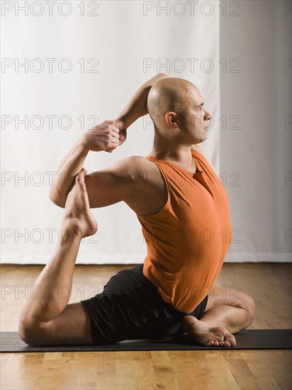 Hispanic man practicing yoga