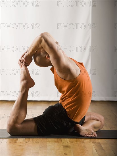 Hispanic man practicing yoga