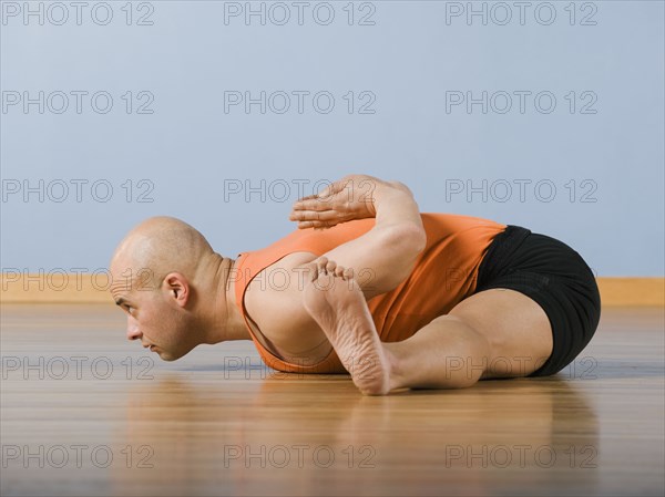 Hispanic man practicing yoga