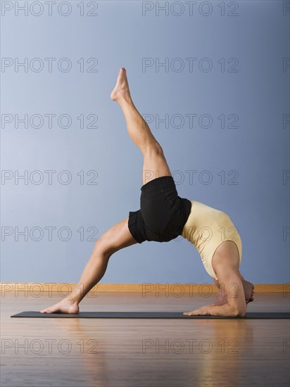 Hispanic man practicing yoga