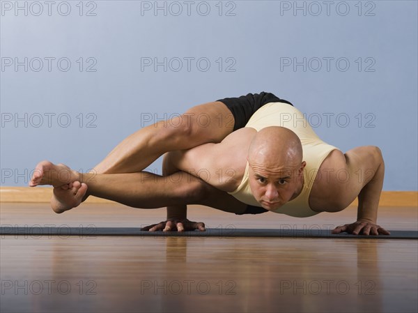 Hispanic man practicing yoga