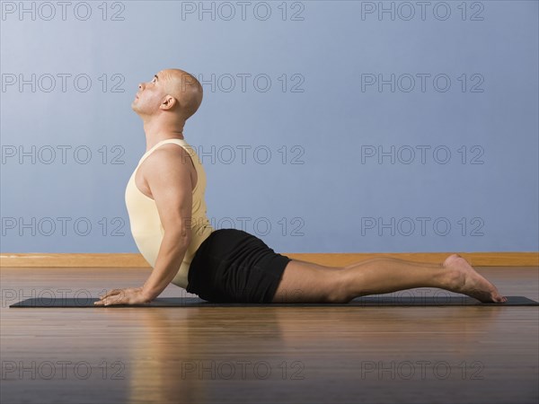 Hispanic man practicing yoga