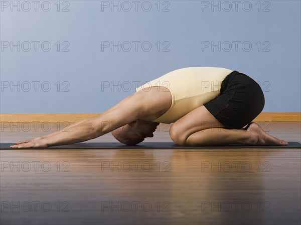 Hispanic man practicing yoga