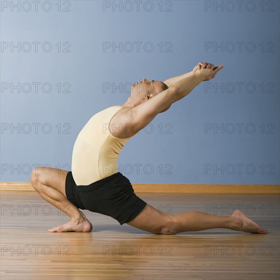 Hispanic man practicing yoga