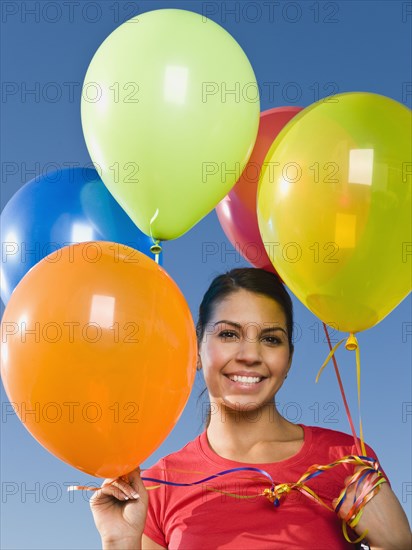 Native American holding balloons