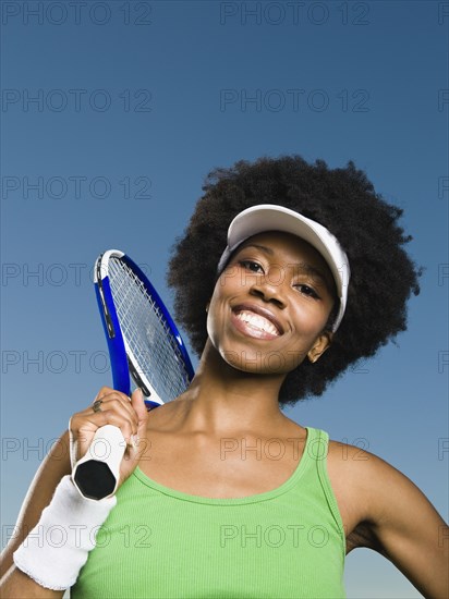 African woman holding tennis racquet