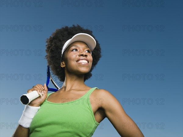 African woman holding tennis racquet