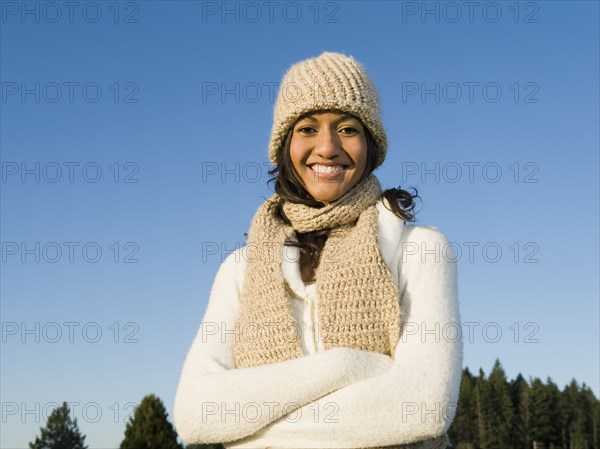 Portrait of mixed race woman smiling with arms crossed