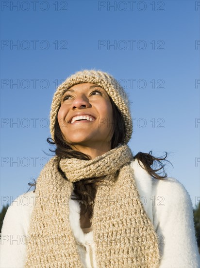 Mixed race woman looking up and smiling