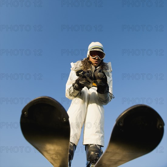 Mixed race woman skiing