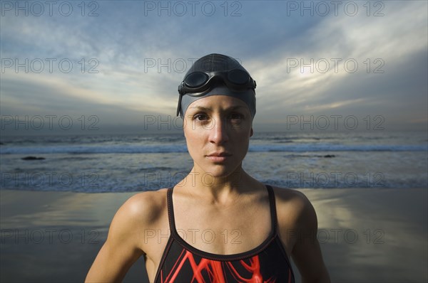 Hispanic woman in bathing suit on beach