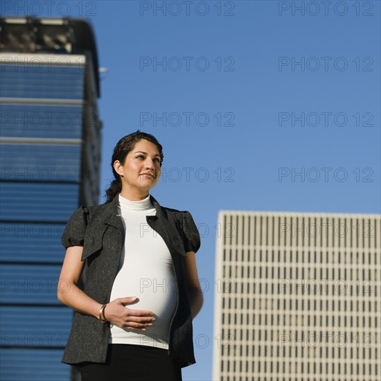 Pregnant Middle Eastern woman rubbing stomach