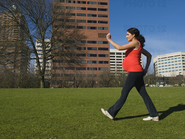 Pregnant Middle Eastern woman walking for exercise