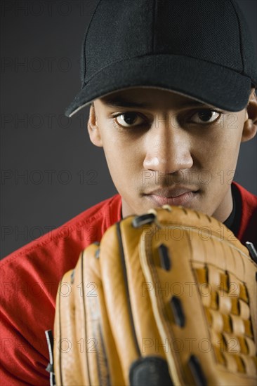 Mixed race baseball player looking serious